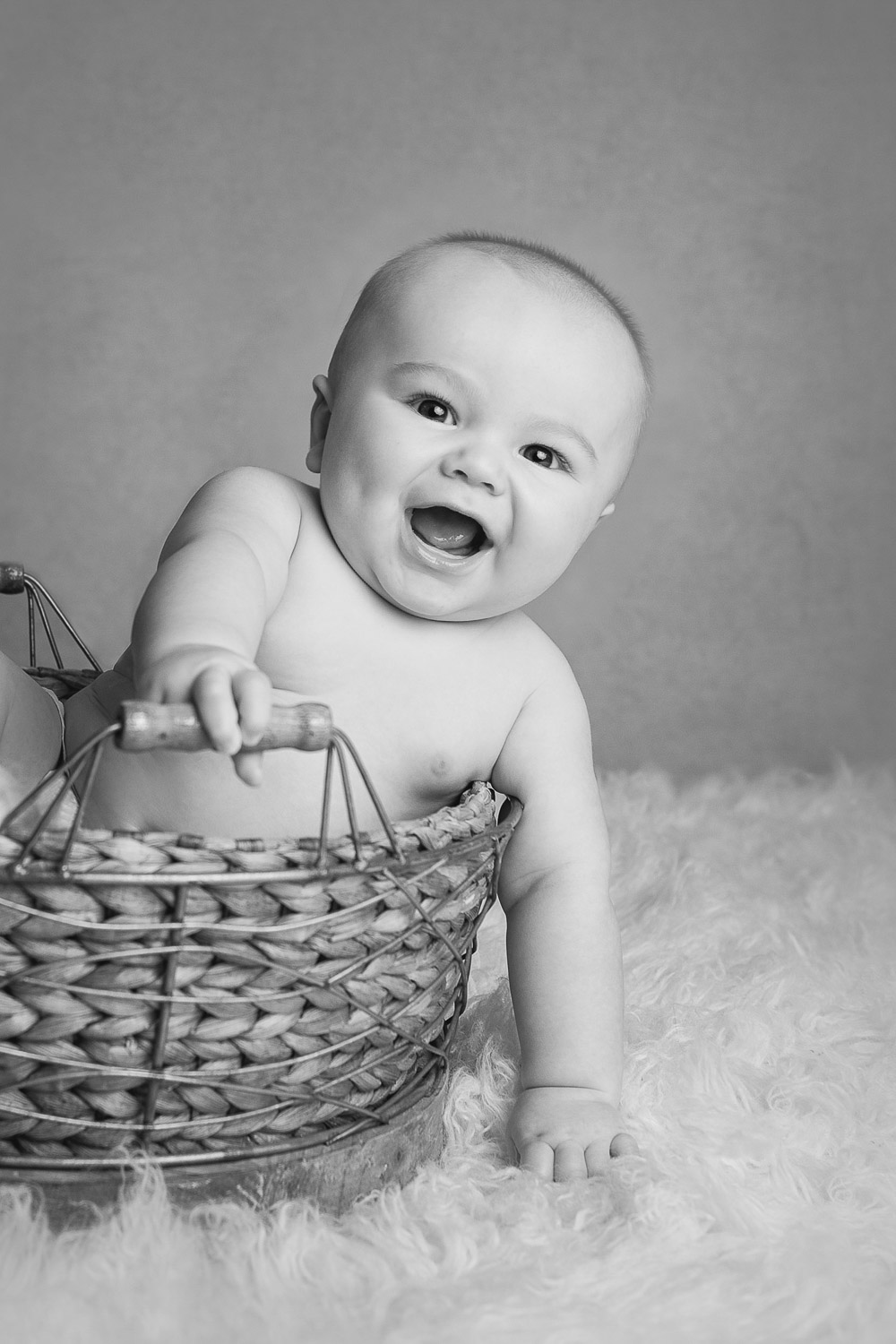 baby in basket smiling