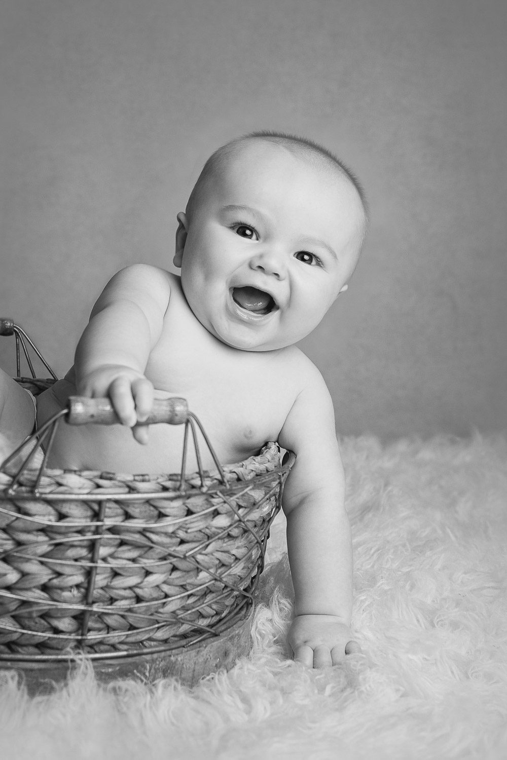 baby in basket smiling