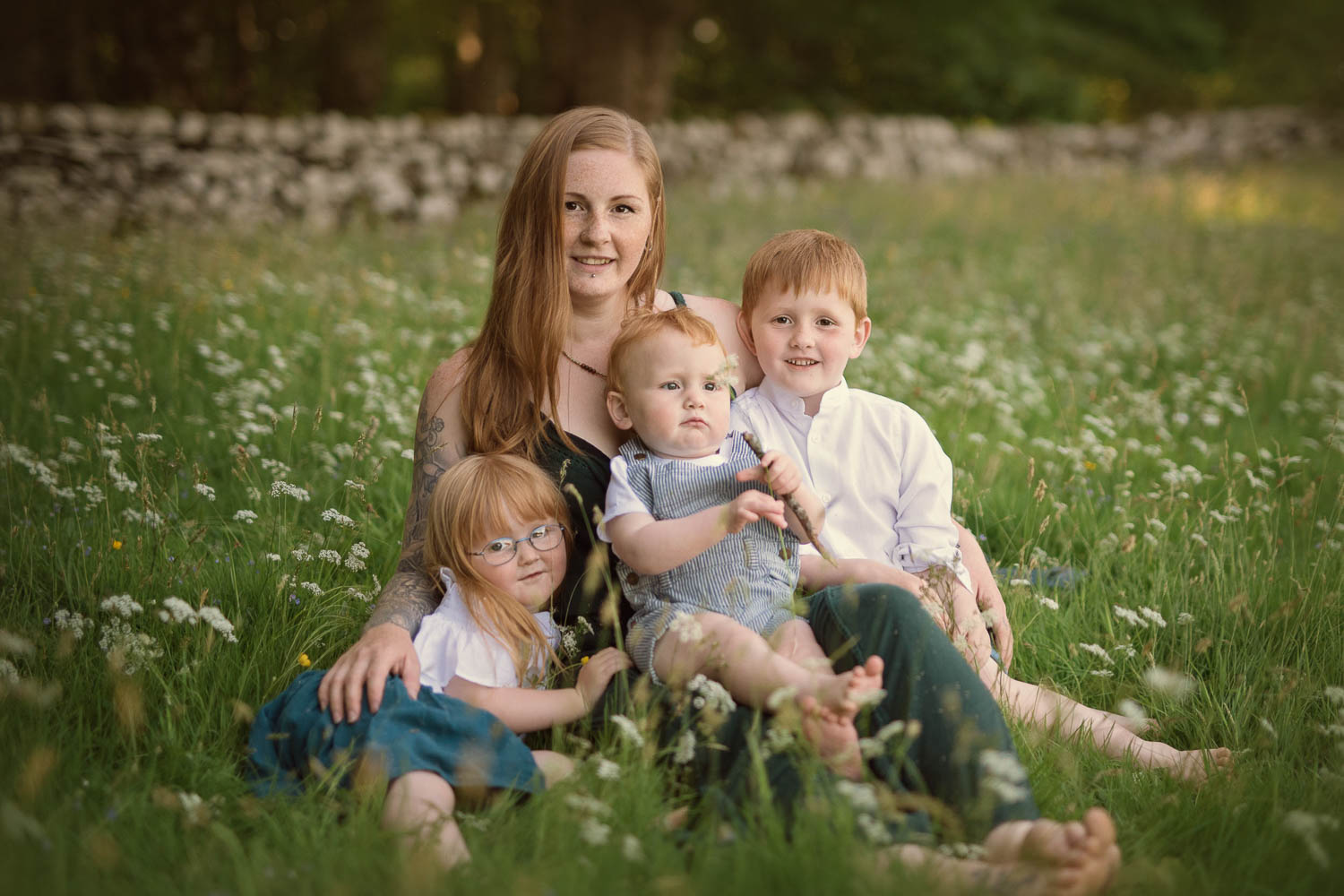 family in grass by family photographer siobhan kelly