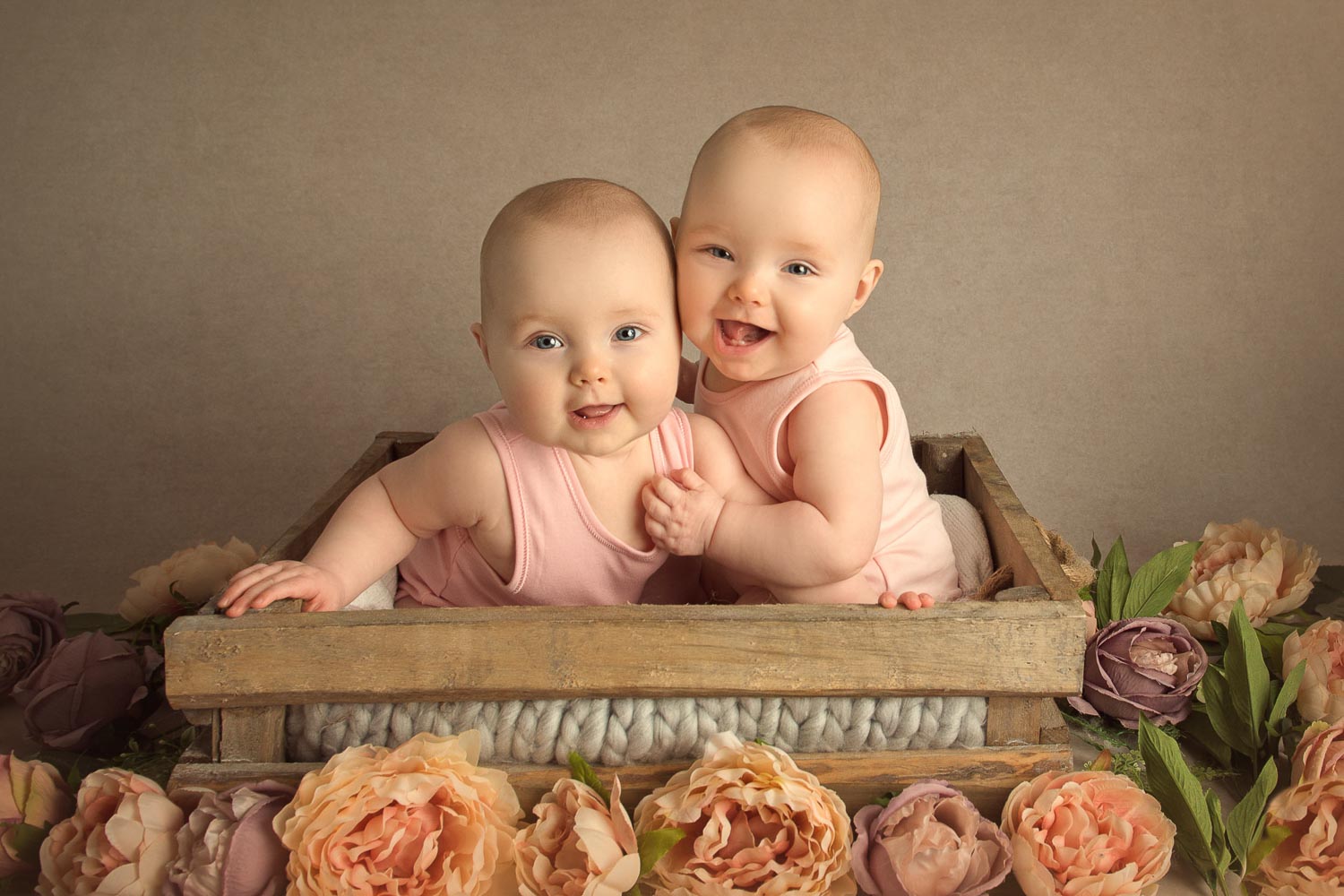 twin babies in a box with flowers by baby photographer siobhan kelly photography