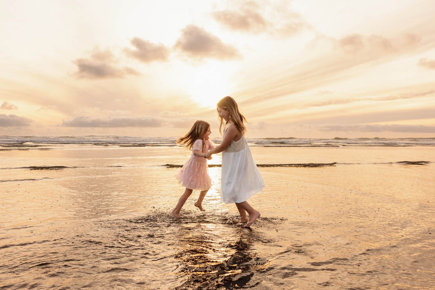 Auckland Family Photography 14 two girls dancing on the beach by family photographer siobhan kelly