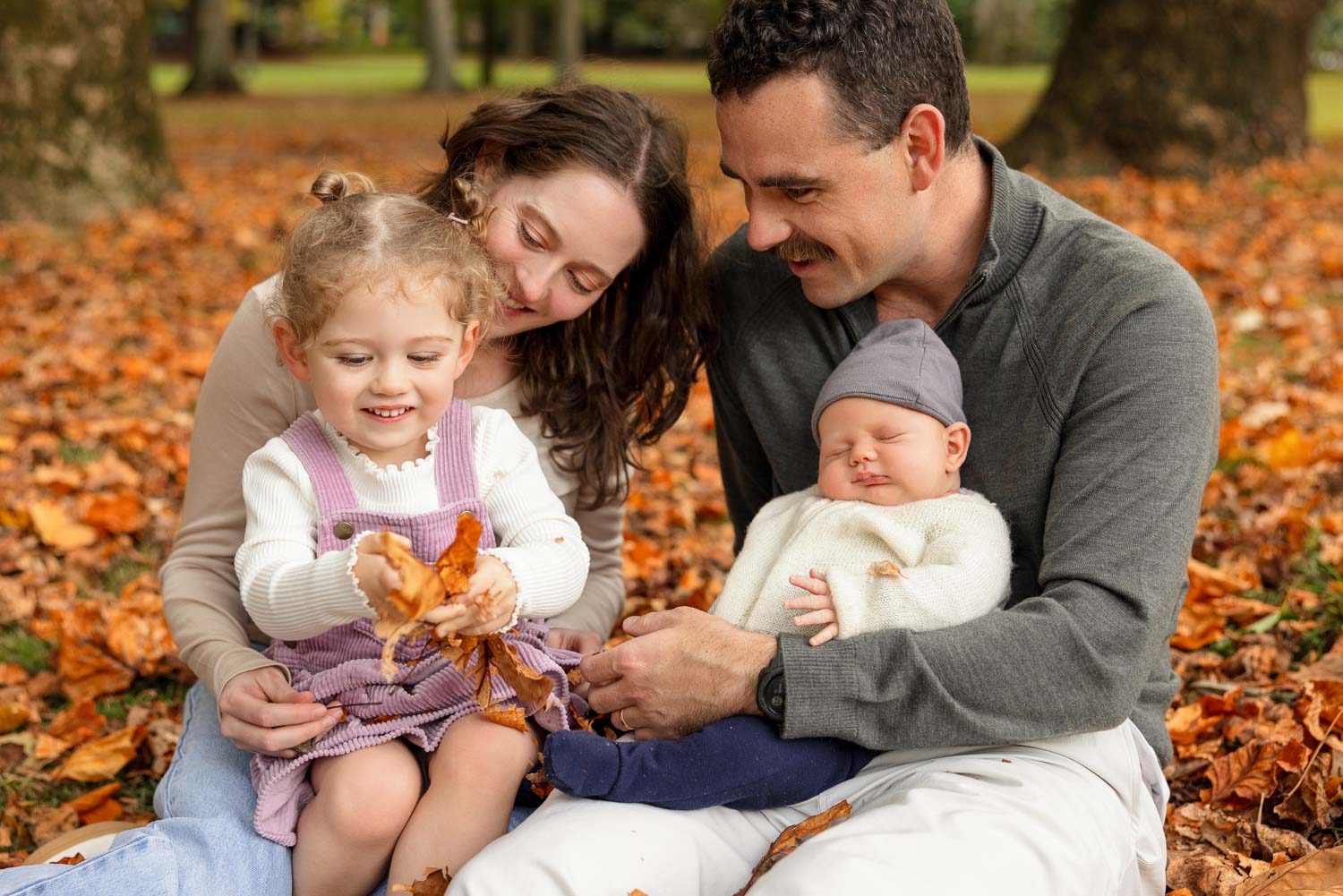 family in autumn leaves by family photographer siobhan kelly